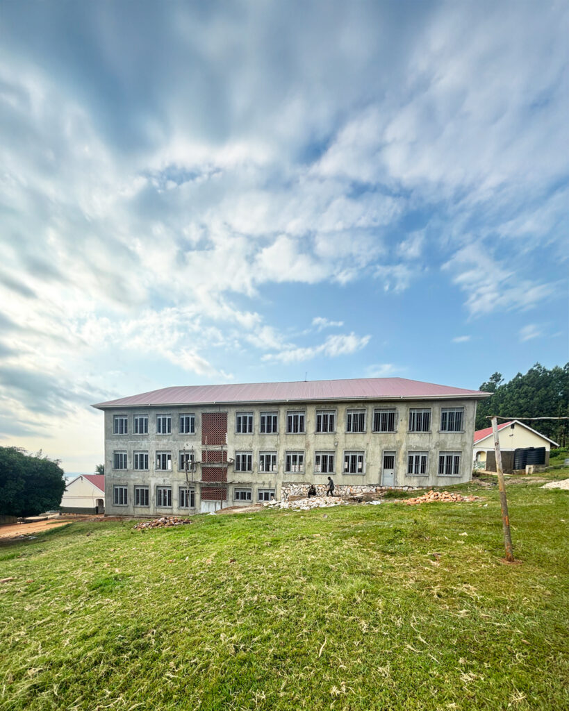 The last picture on this blog shows the green field with the new classroom block in the centre, along with some blue cloudy skies above.