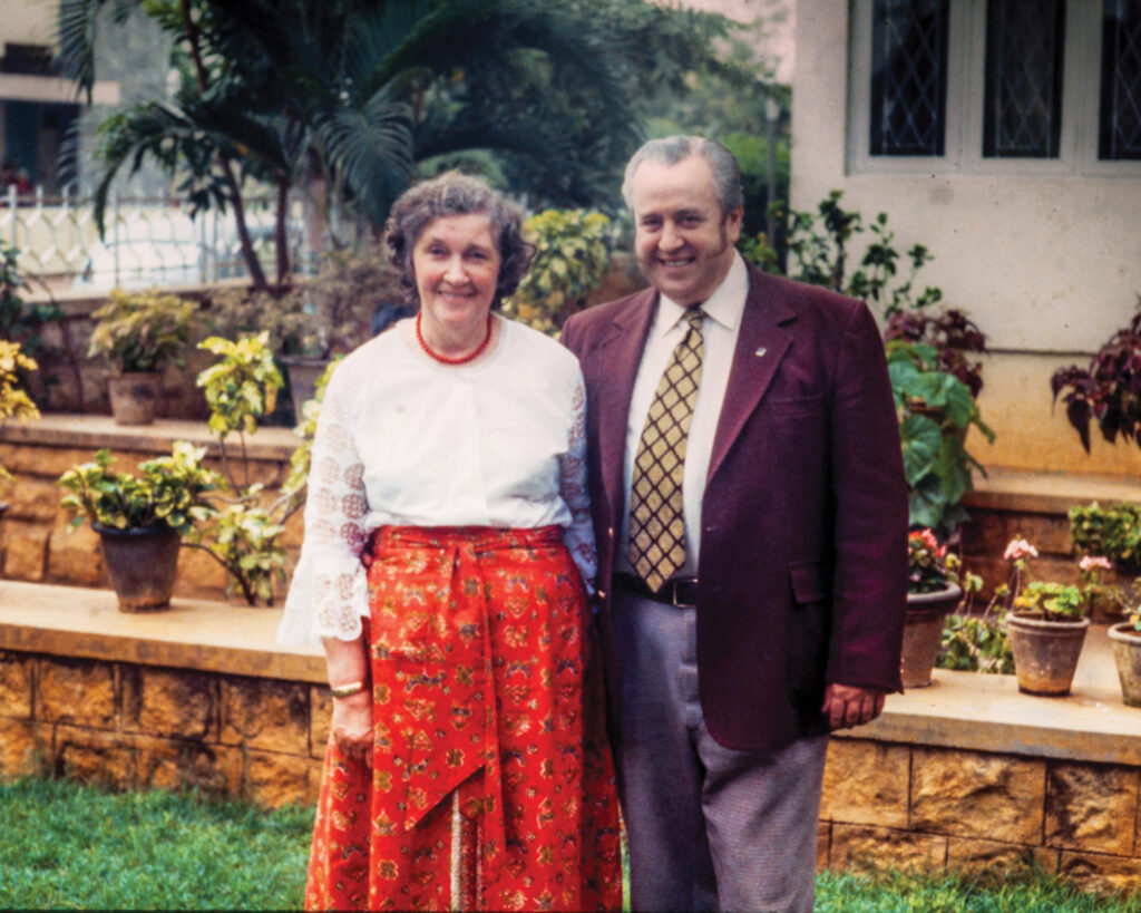 Ray Harrison pictured in a suit with his wife