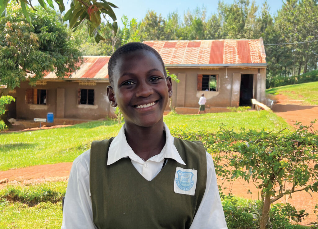 A young female student smiles in her school uniform