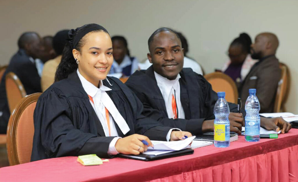 Samuel smiles with his friend at an inter-university law competition