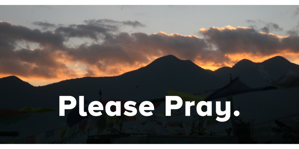 An image of Nepali mountain range at sunset and text saying 'please pray' overlayed