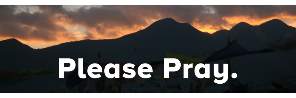 Nepali mountain skyline at sunset with text over saying 'Please Pray.'