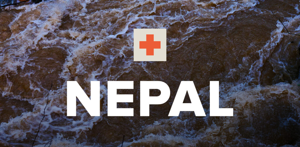 Image of flood water with an emergency symbol and text saying 'NEPAL' overlayed